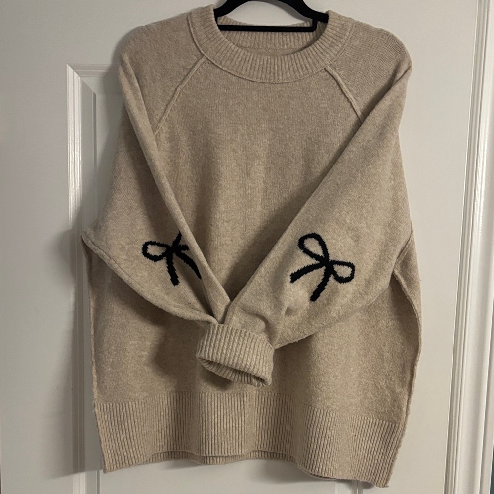 Size Medium Aerie Oversized Beige Sweater with Black Bow Accents